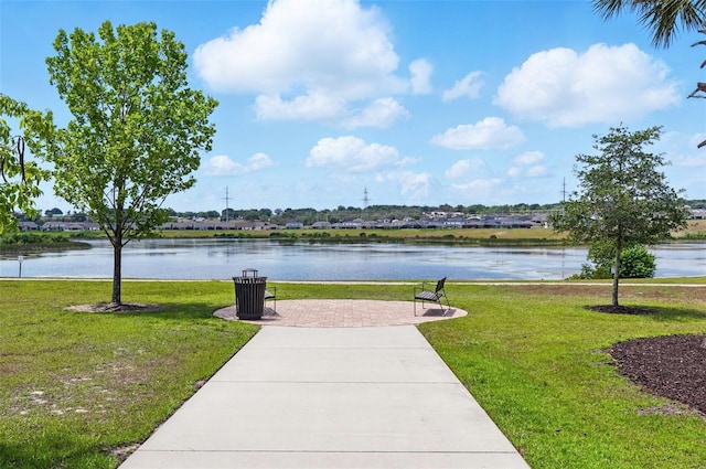 view of community with a yard and a water view