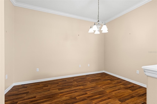 2376 Palm Tree Dr, Kissimmee, FL 34759 - spare room featuring crown molding, a chandelier, dark wood finished floors, and baseboards