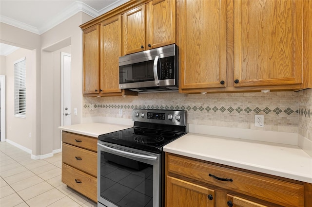 2376 Palm Tree Dr, Kissimmee, FL 34759 - kitchen featuring appliances with stainless steel finishes, crown molding, light tile patterned floors, tasteful backsplash, and light countertops
