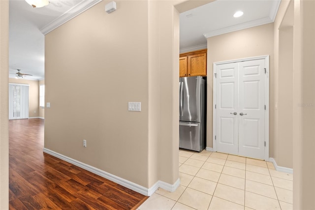 2376 Palm Tree Dr, Kissimmee, FL 34759 - hallway with ornamental molding, baseboards, and light wood-style floors