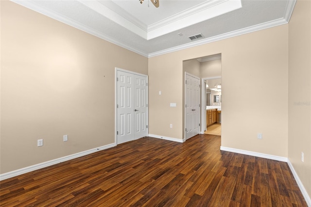 2376 Palm Tree Dr, Kissimmee, FL 34759 - unfurnished bedroom featuring a tray ceiling, dark wood-type flooring, ornamental molding, baseboards, and a chandelier