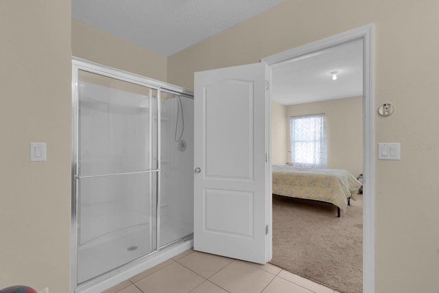 561 Lake Cummings Way, Lake Alfred, FL 33850 - bathroom with a stall shower, tile patterned flooring, and ensuite bath