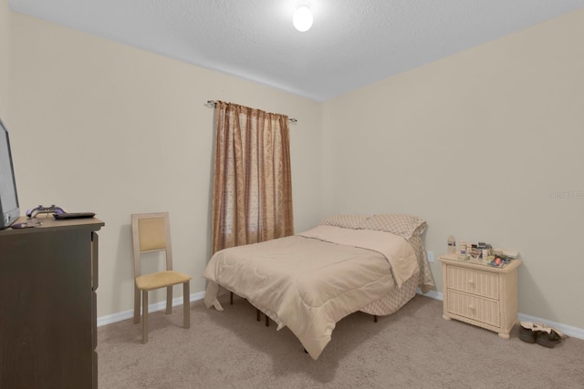 561 Lake Cummings Way, Lake Alfred, FL 33850 - bedroom with light carpet, baseboards, and a textured ceiling