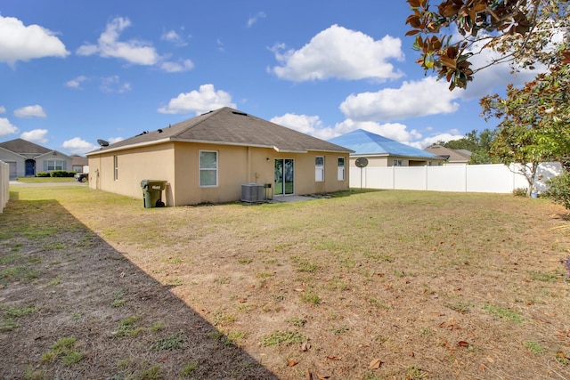 561 Lake Cummings Way, Lake Alfred, FL 33850 - rear view of property with stucco siding and central AC unit