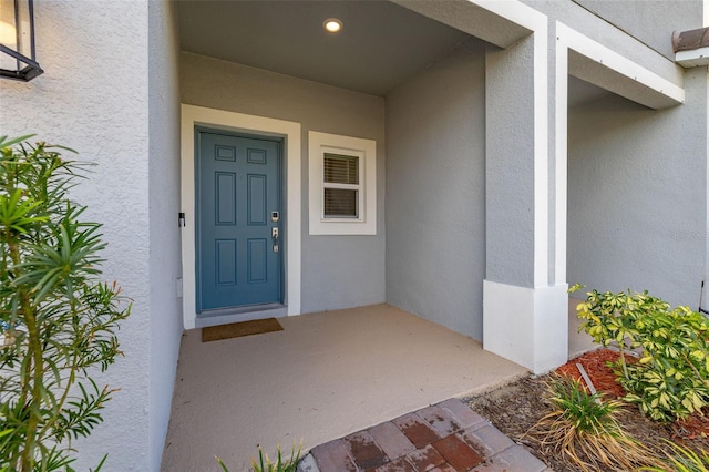 property entrance with stucco siding