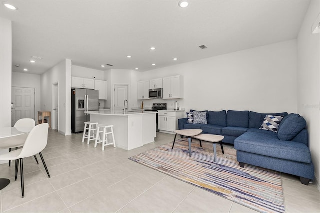 living room with recessed lighting and light tile patterned floors