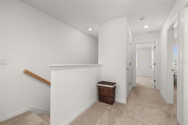 corridor with carpet, an upstairs landing, baseboards, and recessed lighting