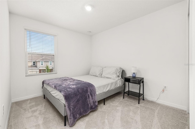 bedroom featuring carpet flooring and baseboards
