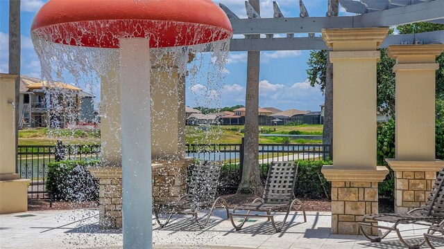 view of patio / terrace with fence, a pergola, and a residential view