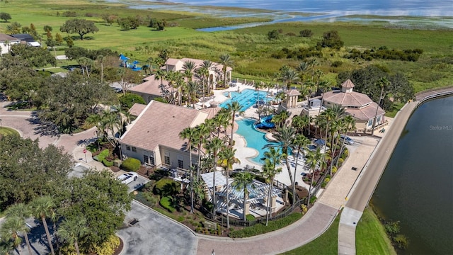 aerial view of a pool area and a large body of water