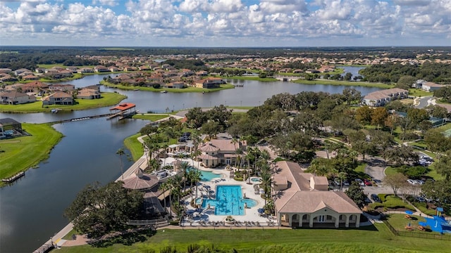aerial view of residential area with a large body of water and a pool area