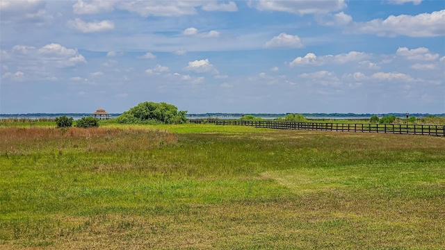 view of yard featuring fence and a view of rural / pastoral area