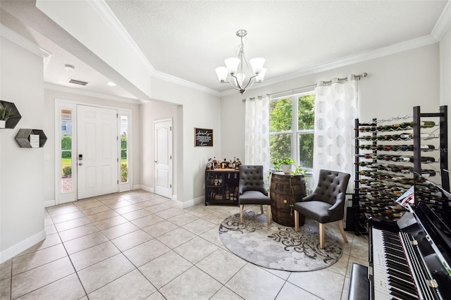 foyer featuring a chandelier, crown molding, light tile patterned floors, and baseboards