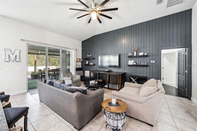 living area featuring a ceiling fan, light tile patterned floors, baseboards, and high vaulted ceiling