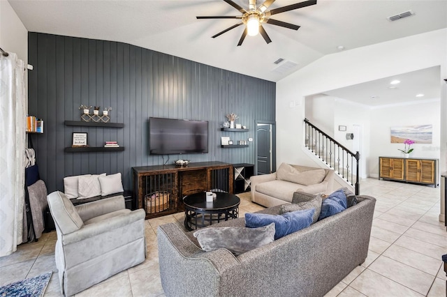 living area featuring vaulted ceiling, a ceiling fan, stairway, and light tile patterned floors
