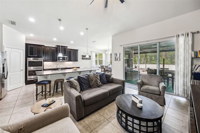 living area with light tile patterned flooring, recessed lighting, and a ceiling fan