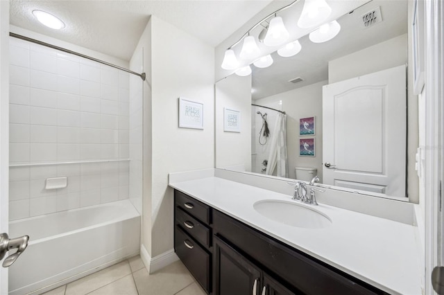 full bathroom featuring tile patterned floors, toilet, vanity, and shower / bath combo with shower curtain