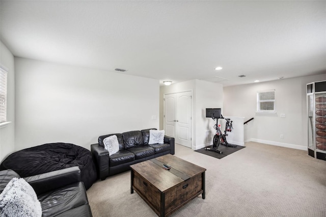 living room with light carpet, recessed lighting, healthy amount of natural light, and baseboards