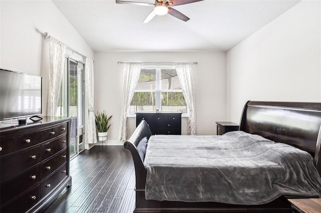 bedroom with dark wood finished floors, lofted ceiling, ceiling fan, and baseboards