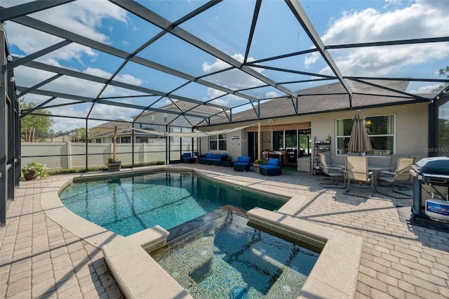 view of swimming pool with a patio area, a pool with connected hot tub, fence, and a lanai