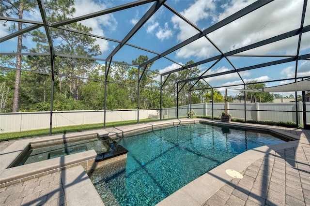 view of swimming pool featuring a fenced backyard, an outdoor hot tub, and glass enclosure
