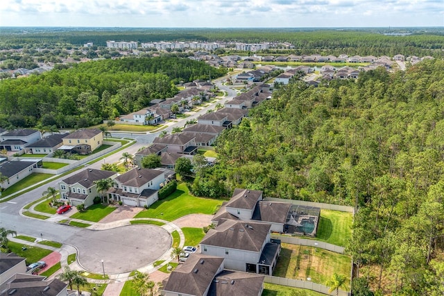 aerial overview of property's location with nearby suburban area and a heavily wooded area