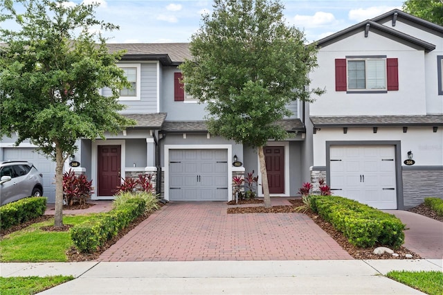 352 Smugglers Way, Apopka, FL 32712 - multi unit property featuring decorative driveway, stucco siding, a garage, and roof with shingles