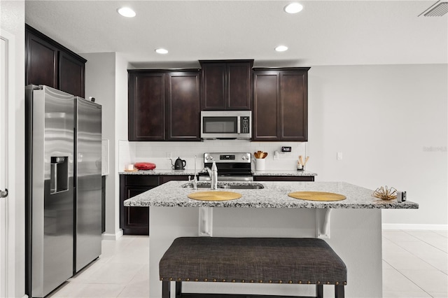 352 Smugglers Way, Apopka, FL 32712 - kitchen featuring appliances with stainless steel finishes, light tile patterned flooring, light stone counters, tasteful backsplash, and recessed lighting