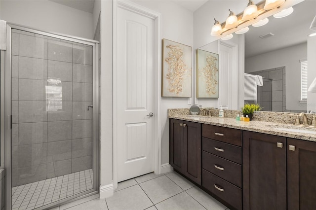 420 Burma St, Kissimmee, FL 34747 - bathroom featuring a shower stall, tile patterned floors, and double vanity