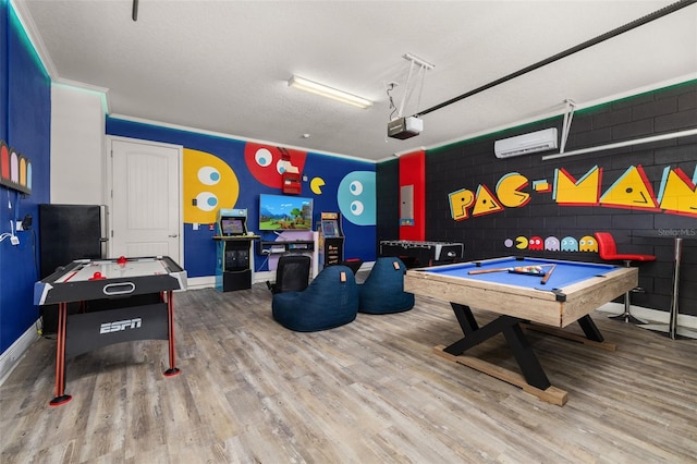 420 Burma St, Kissimmee, FL 34747 - recreation room featuring wood finished floors, billiards, a wall mounted AC, concrete block wall, and electric panel