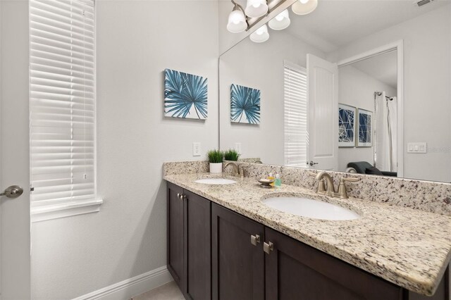 420 Burma St, Kissimmee, FL 34747 - bathroom with double vanity and baseboards