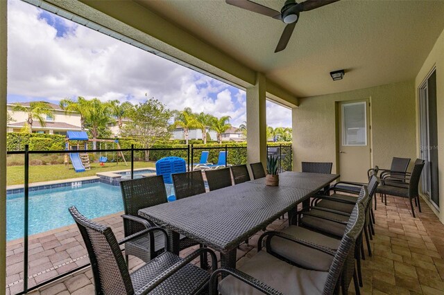 420 Burma St, Kissimmee, FL 34747 - view of patio / terrace with ceiling fan, a pool with connected hot tub, and outdoor dining space