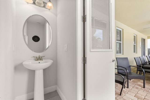 420 Burma St, Kissimmee, FL 34747 - bathroom with baseboards and a sink
