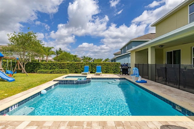 420 Burma St, Kissimmee, FL 34747 - view of pool featuring area for grilling, a pool with connected hot tub, a playground, and a patio