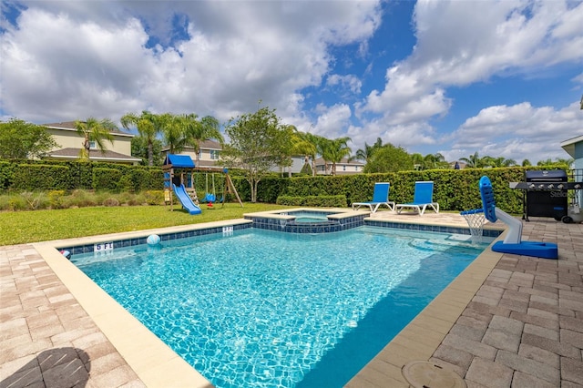 420 Burma St, Kissimmee, FL 34747 - view of swimming pool with a grill, a playground, a patio area, and a pool with connected hot tub