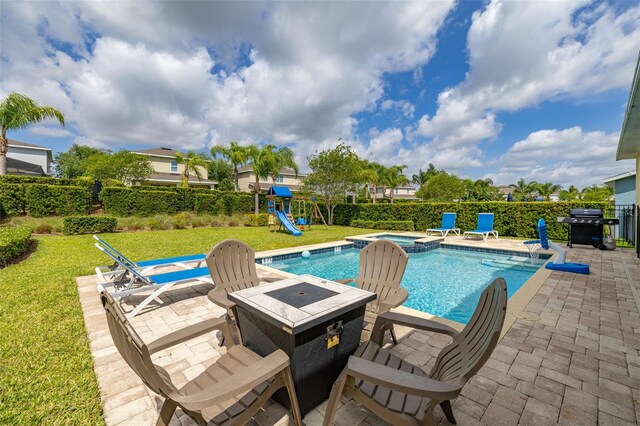 420 Burma St, Kissimmee, FL 34747 - view of pool featuring a patio, a playground, area for grilling, a pool with connected hot tub, and a fenced backyard