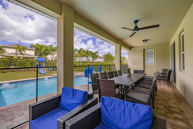 420 Burma St, Kissimmee, FL 34747 - fenced backyard featuring ceiling fan, outdoor dining space, a patio, and a pool with connected hot tub