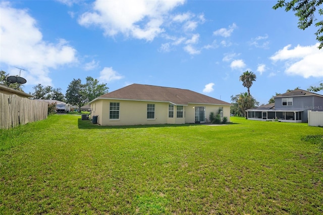 14091 SW 32nd Terrace Rd, Ocala, FL 34473 - rear view of property featuring a yard and stucco siding