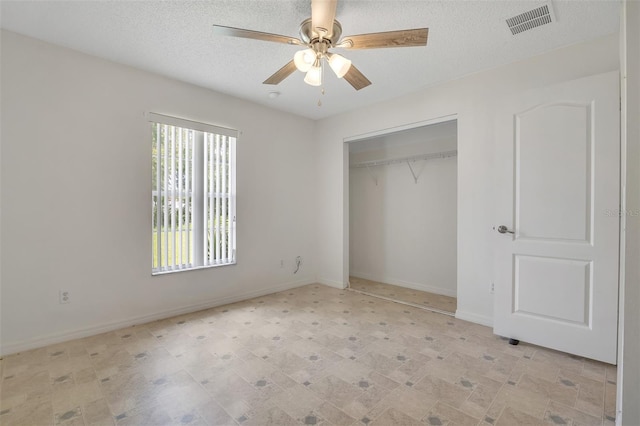 14091 SW 32nd Terrace Rd, Ocala, FL 34473 - unfurnished bedroom with a textured ceiling, a closet, and a ceiling fan