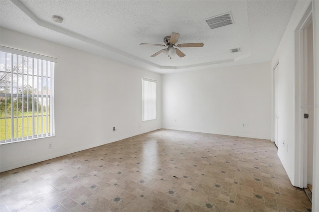 14091 SW 32nd Terrace Rd, Ocala, FL 34473 - spare room with a raised ceiling, a ceiling fan, a smoke detector, and a textured ceiling