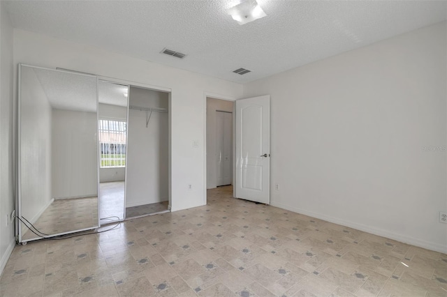 14091 SW 32nd Terrace Rd, Ocala, FL 34473 - unfurnished bedroom with a textured ceiling and a closet