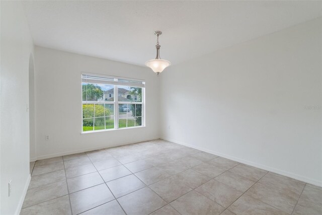 4630 Elena Way, Melbourne, FL 32934 - empty room featuring light tile patterned floors and baseboards