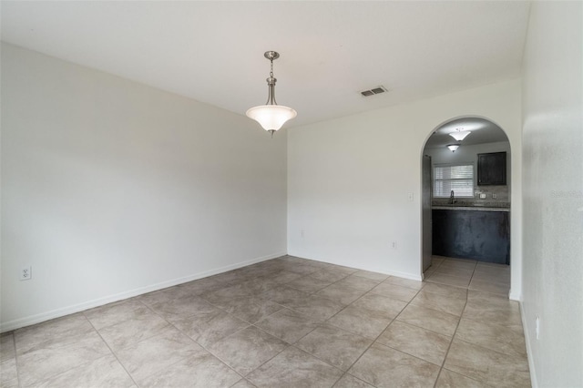 4630 Elena Way, Melbourne, FL 32934 - unfurnished room with arched walkways, a sink, and light tile patterned floors
