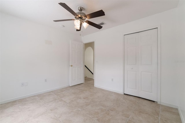 4630 Elena Way, Melbourne, FL 32934 - unfurnished bedroom featuring baseboards, ceiling fan, a closet, and light tile patterned floors