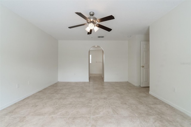 4630 Elena Way, Melbourne, FL 32934 - empty room featuring arched walkways, ceiling fan, and baseboards