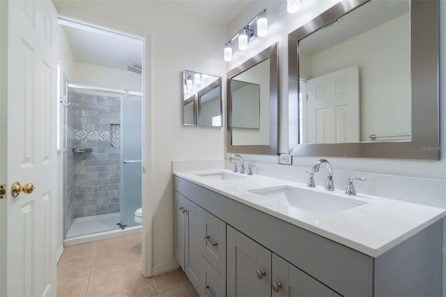 4630 Elena Way, Melbourne, FL 32934 - full bathroom featuring toilet, a stall shower, tile patterned floors, and double vanity