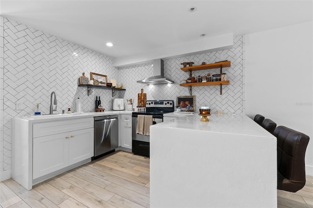 5234 Eaglesmere Dr Unit D04, Orlando, FL 32819 - kitchen with wall chimney exhaust hood, appliances with stainless steel finishes, open shelves, a sink, and recessed lighting