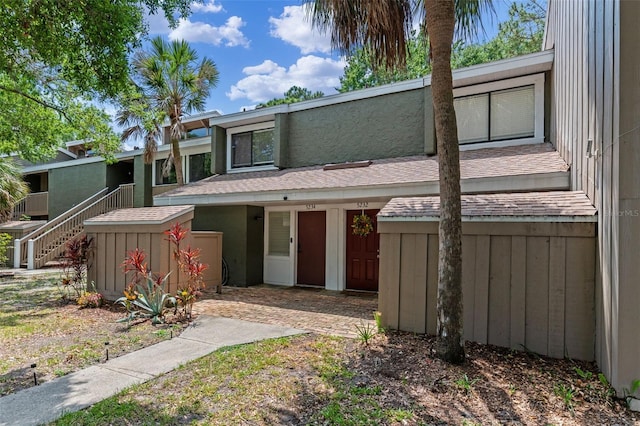 5234 Eaglesmere Dr Unit D04, Orlando, FL 32819 - mid-century modern home featuring roof with shingles