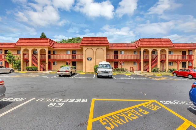 2864 N Powers Dr Unit 150, Orlando, FL 32818 - view of property with uncovered parking and stairway
