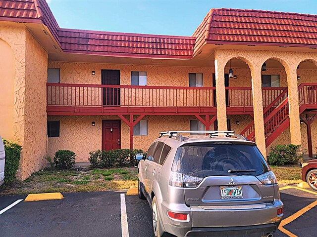 2864 N Powers Dr Unit 150, Orlando, FL 32818 - view of building exterior featuring uncovered parking